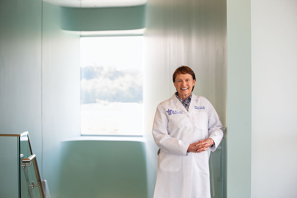 Sharon Frey, M.D., standing in a hallway of the Doisy research building