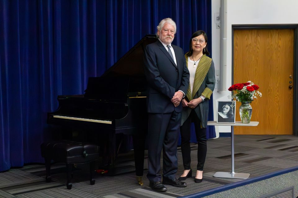 Stephen C. Peiper, and his wife Zi-Xuan "Zoe" Wang, Ph.D. in front of a pciture of Gwendolyn Peiper
