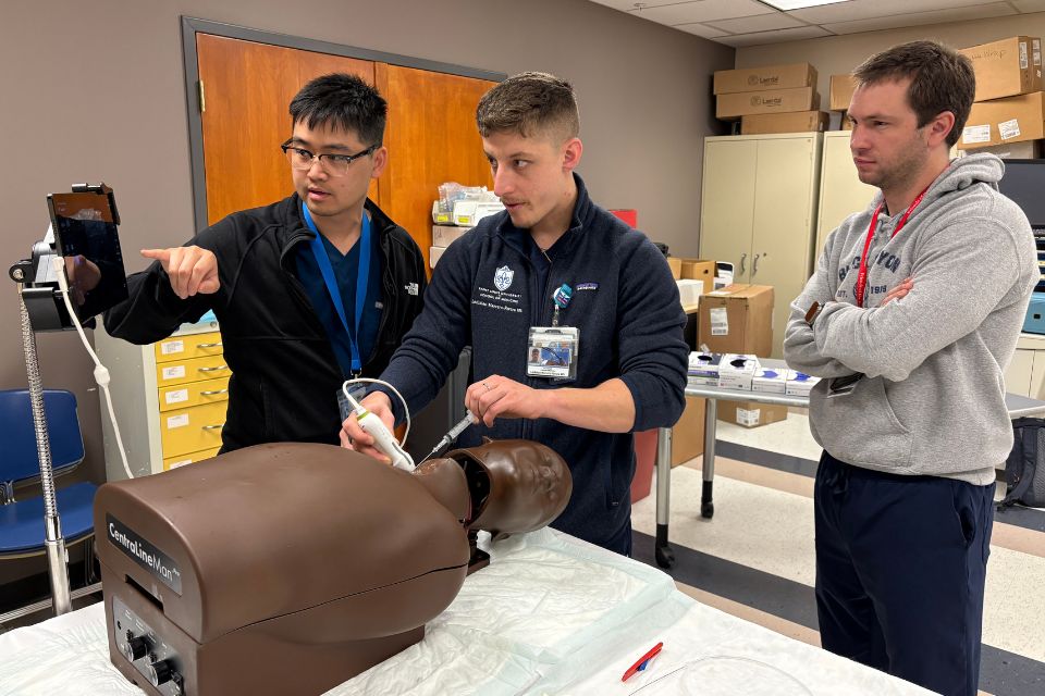 Internal medicine residents practice point of care ultrasound training on a mannequin