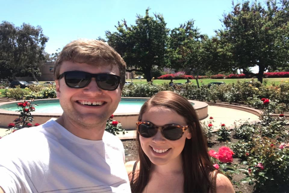 Daniel Daniel standing in a garden with a friend wearing sunglasses.