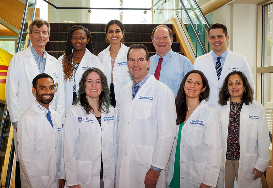 Group picture of Child Residency Neurology. Seven residents and 3 instructors stand on a staircase together. 