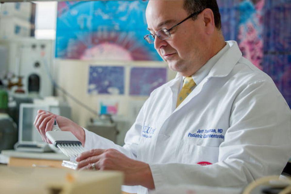 Jeffrey Teckman, M.D., uses an electronic, multichannel pipette in his lab.