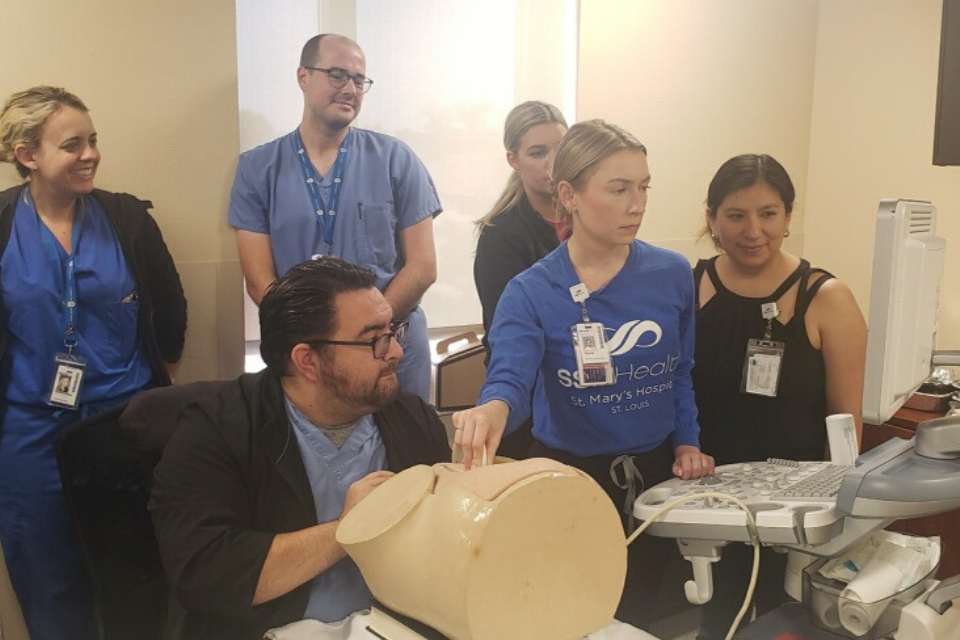 Fellow working in a sim lab, peforming an ultra sound