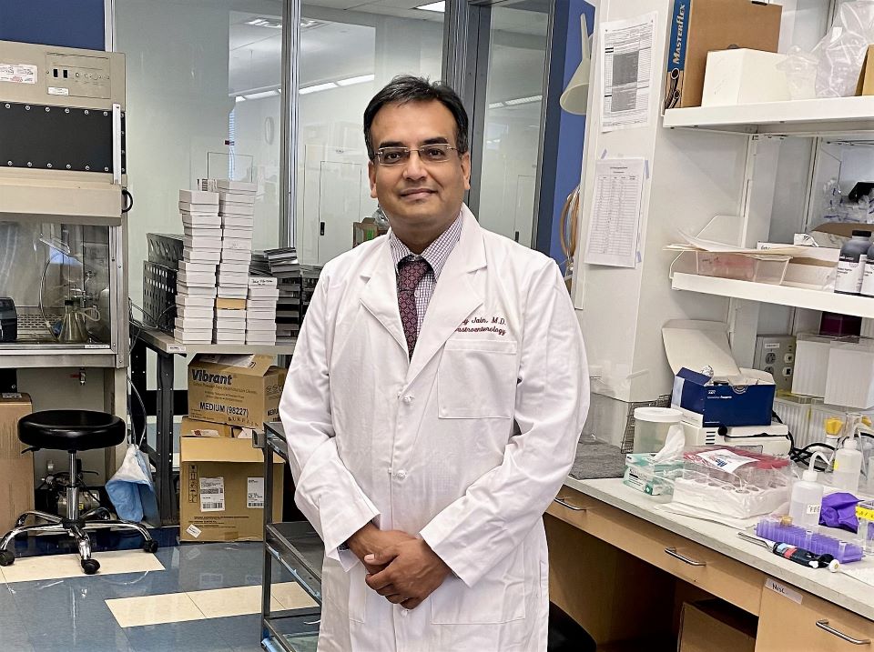Photo of Dr. Ajay Jain standing in his labratory