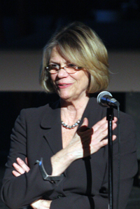 Pamela Ambrose Pamela Ambrose stands before a microphone while addressing an audience