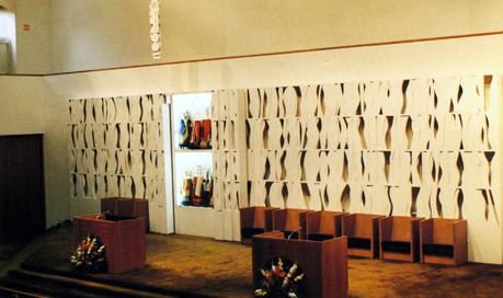 The sanctuary of Temple Beth-El, with a bema wall, ark, and eternal light designed by Louise Nevelson.