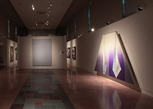An installation view of MOCRA's nave gallery features paintings by James Rosen and Daniel Ramirez, with other works in the background.