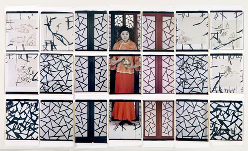 An artwork by Maria Magdalena Campos-Pons titled, Painting Lesson. In a seven-across by three-deep grid of photographs, the artist occupies the central column dressed in an elaborate costume with her skin painted white. Abstracted geometric panels are seen to either side.