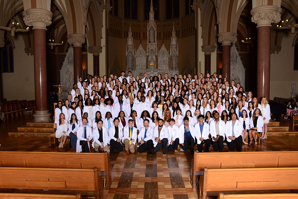 Students from all three nursing pathways at the Valentine School of Nursing celebrate receiving their white coats in a unified ceremony on Friday, Sept. 26, at St. Francis Xavier College Church. Photo by Kyle Kabance.