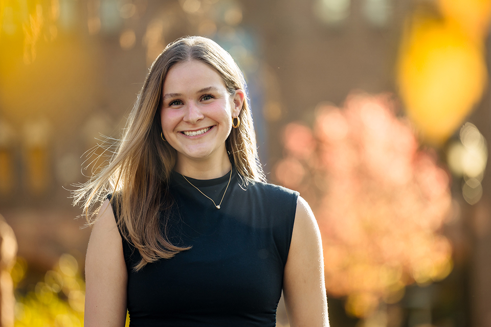 A photo of Lucy Heller outdoors on a fall day.