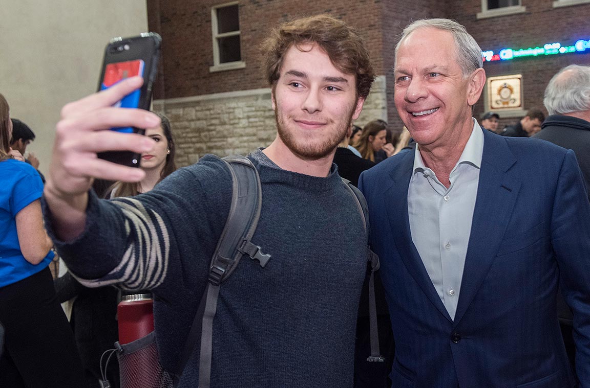 Dr. Richard A. Chaifetz takes a selfie with a student