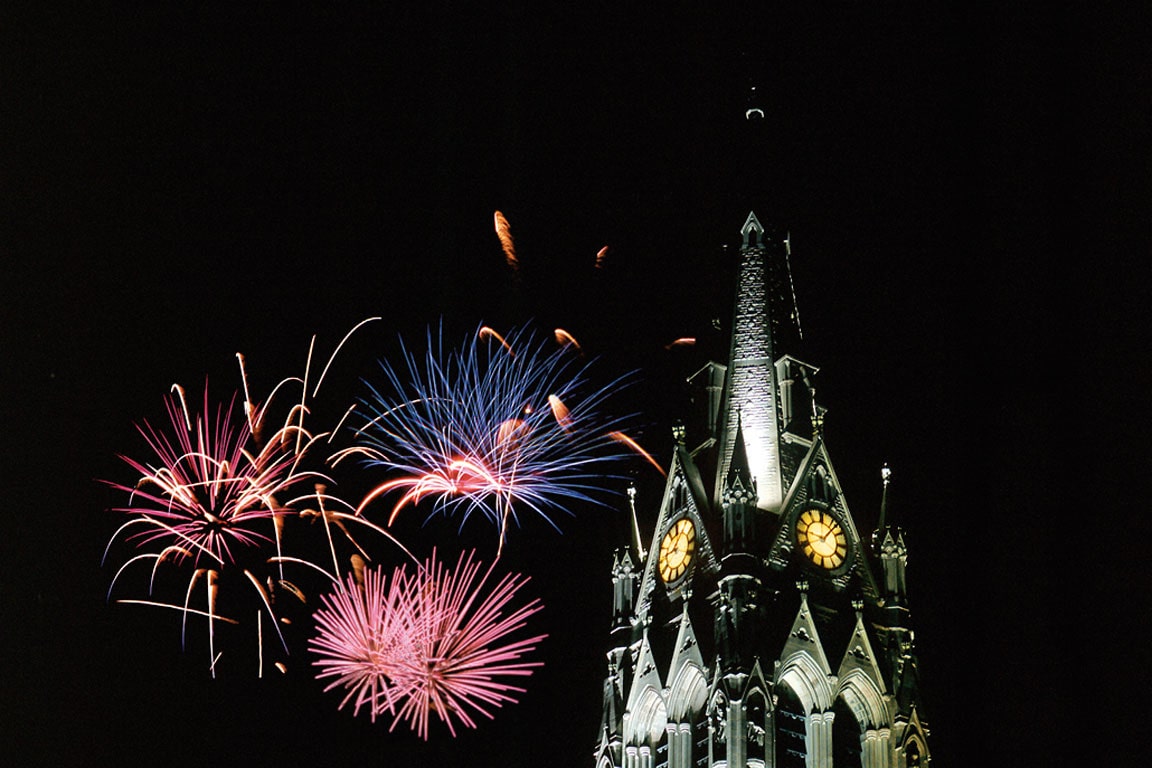 Fireworks go off near the spire of St. Francis Xavier College Church.