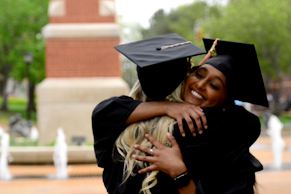 Graduates hug