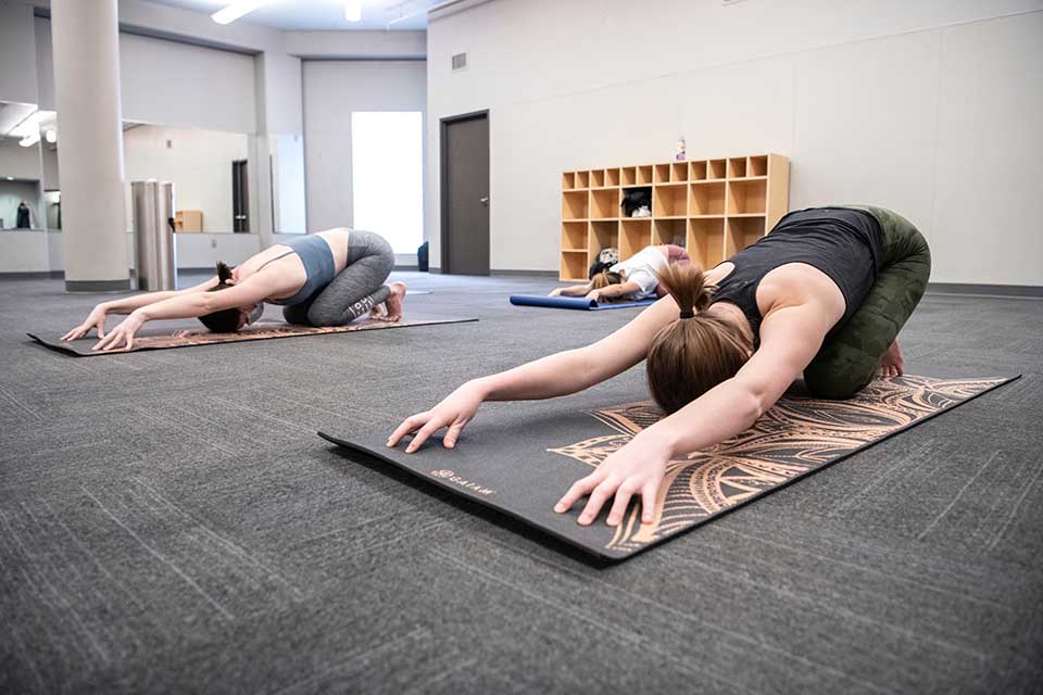 Students take part in a yoga class at the Simon Rec Center in February 2021. A Fill Your Cup yoga class is one of the events on the scheduled for the spring 2023 Wellness Day. Photo by Steve Dolan. 
