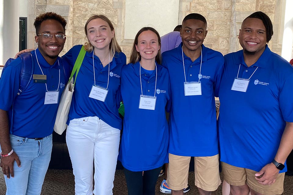 A photo of Executive board members of SGA posing arm-in-arm at a conference.