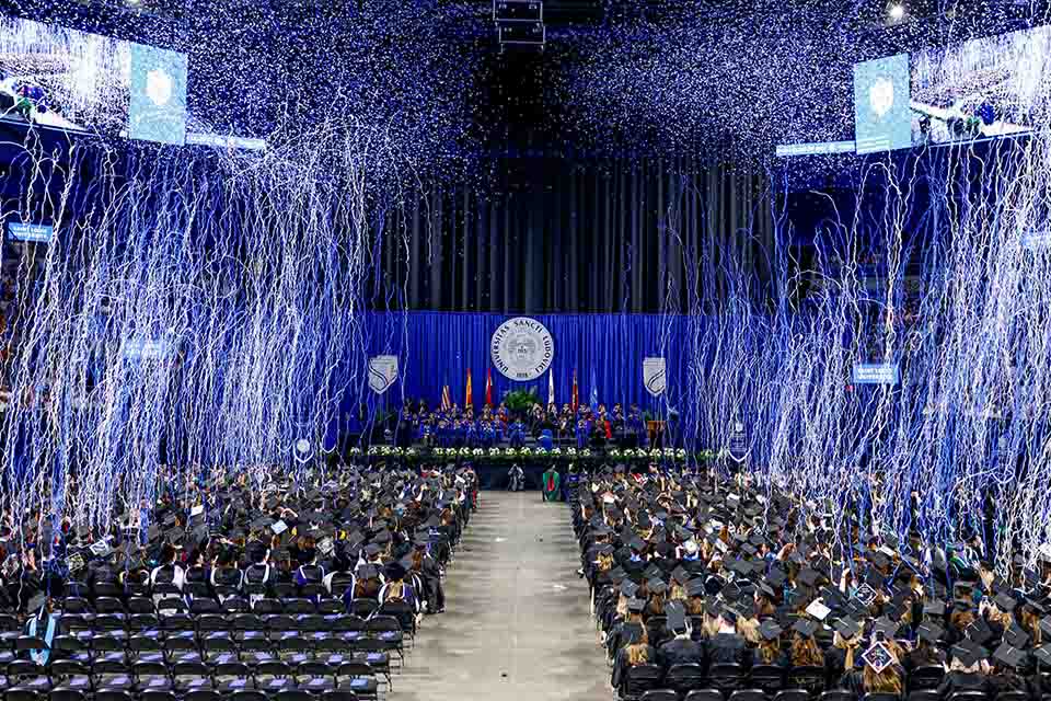 Confetti falls on the Class of 2022 at Commencement Saturday, May 21, 2022. Photo by Sarah Conroy.