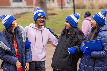 New international students share a laugh on campus during Spring 2023 International Student Orientation. 