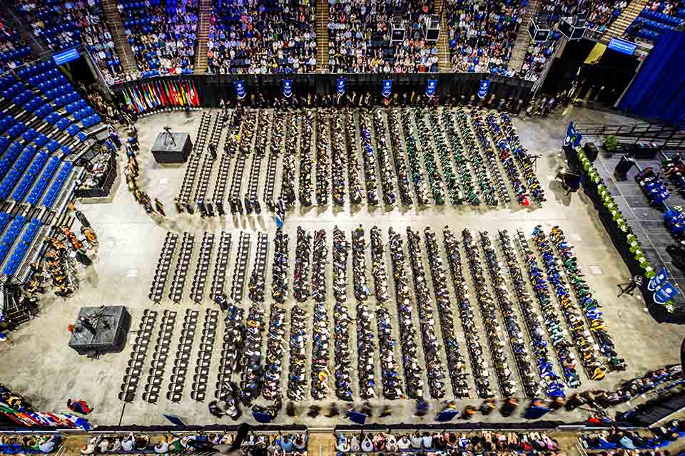 An overhead shot of students filing in for the Spring 2023 commencement ceremony. 