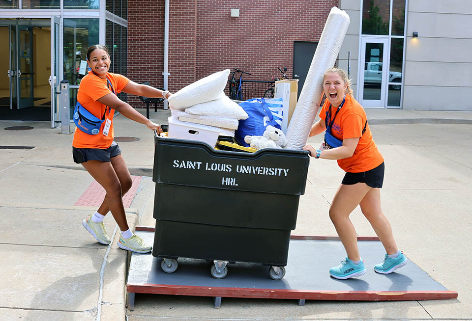 Oriflamme leaders push a cart. 