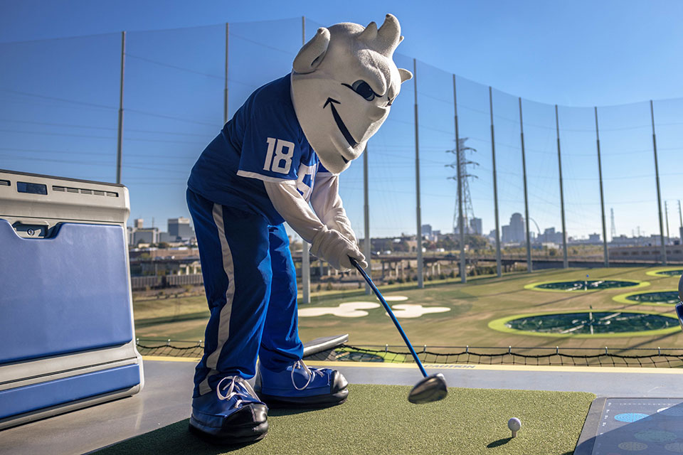 The Billiken tees off at the new Topgolf St. Louis Midtown after the ribbon-cutting ceremony on October 20, 2023.