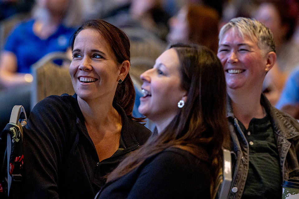 SLU staff members laugh during the Keynote presentation “I Think Therefore I Err: Using Brain Science to Effect Change, Human Connection, and Happiness” by Eric M. Bailey during the Cannonball Conference on Thursday, Oct. 26. Photo by Sarah Conroy.