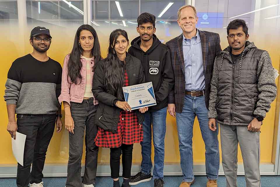 Participants in the Hackathon pose for a photo with Eric Armbrecht, Ph.D. Photo submitted. 