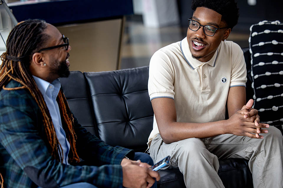 African American Male Scholars mentor Dr. Richard Marks, left, meets with student Russell Hooker on April 26, 2024.