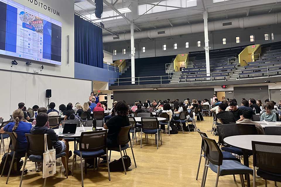 A group of students gather in the CGC for Policy Pods. 