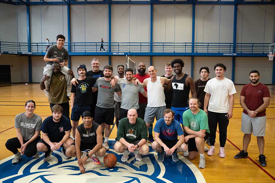 SLU NBA a group of people posing for a photo