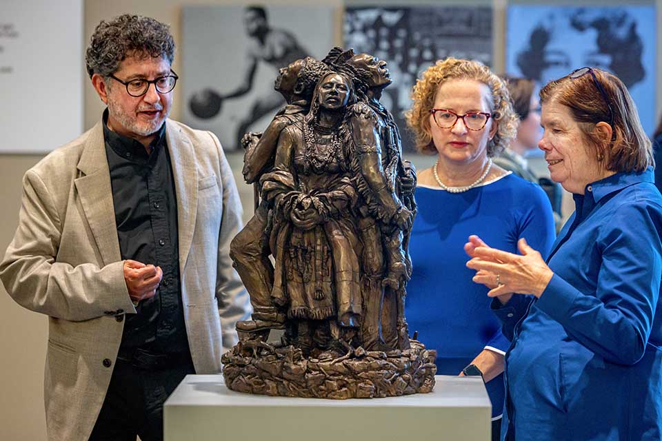 Fran Pestello, Ph.D., discusses the sculpture “Land, Labor, Legacy” by Kyle and Kelly Phelps on April 28, 2025. The sculpture in Pius XII Memorial Library is a gift to the university from the Pestellos.