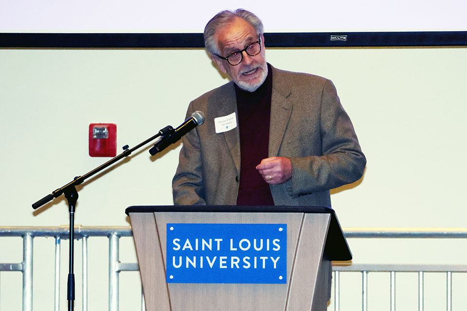 a man speaks at a podium