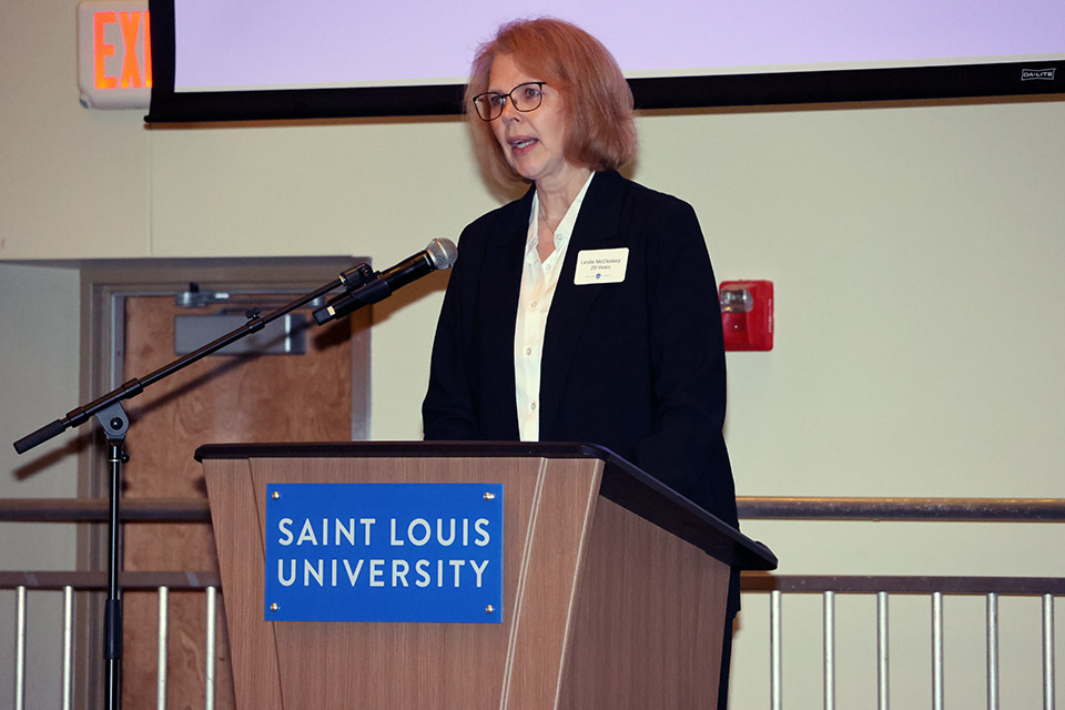 a woman speaks at a podium