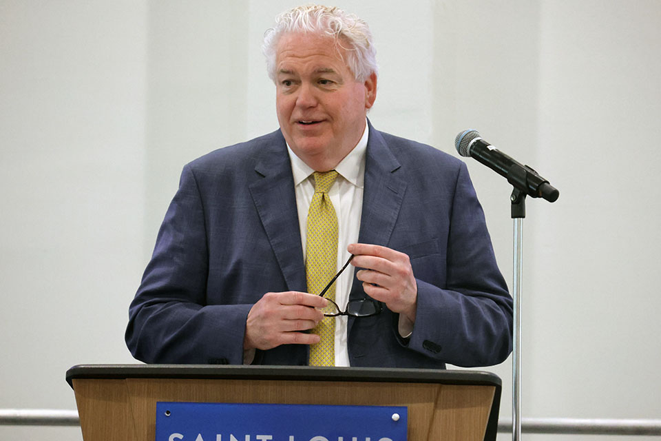 a man in a suit and tie at a podium