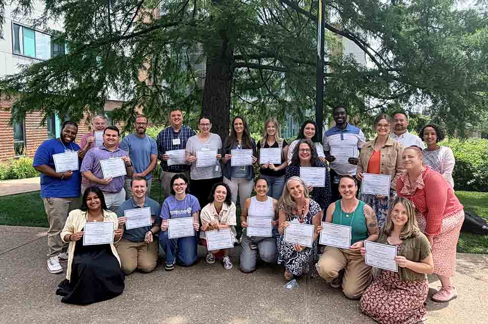 a group of people holding papers
