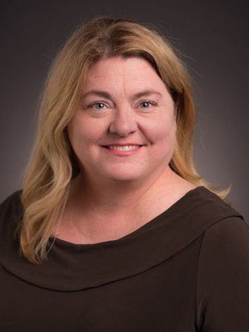 a woman poses for a picture