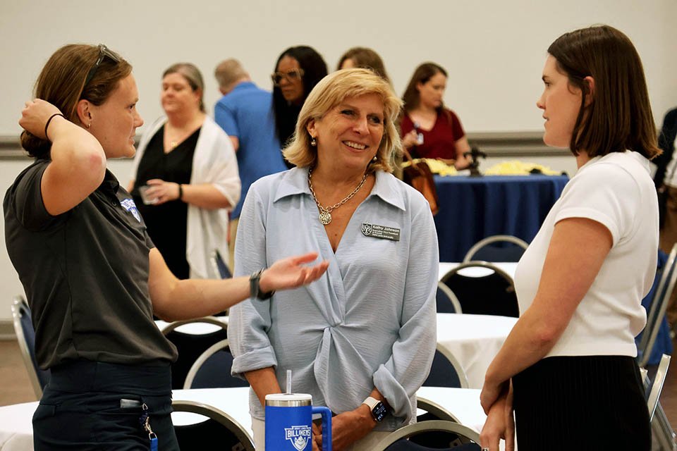 a group of women talking to each other