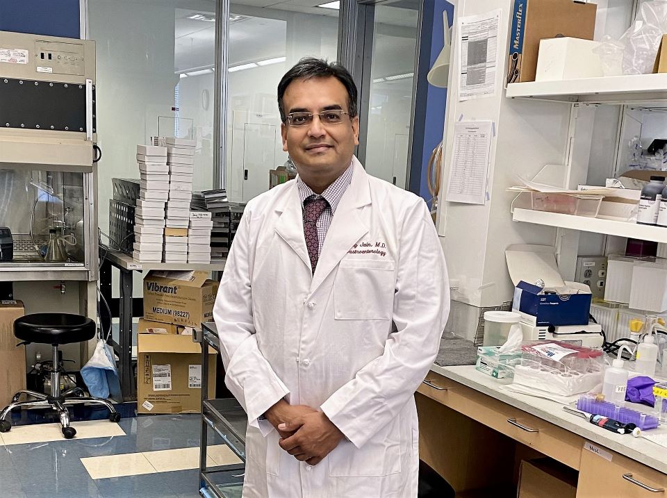 Headshot of Ajay Jain sitting in a lab