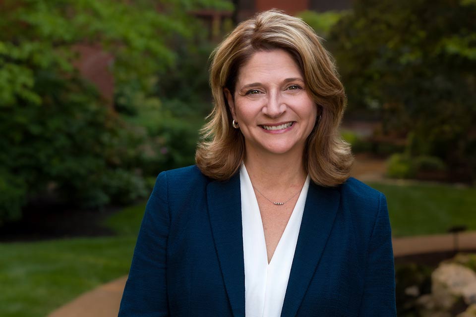 Amy Bollinger wearing a blue jacket and white shirt