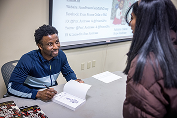 Stanley Andrisse, Ph.D., applied to six biomedical graduate programs. He was rejected from all but one – SLU, he said during a discussion and book signing hosted by SLU’s Prison Education Program on Friday, Jan. 20, at the Busch Student Center. He credited a mentor from SLU who served on the admission committee with giving him a second chance.  