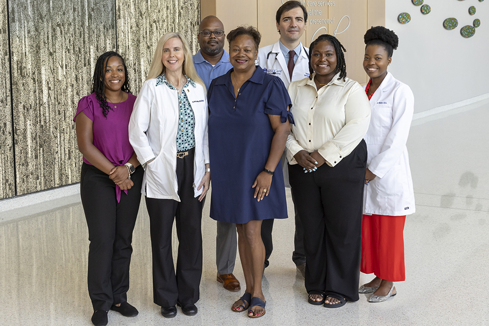 A group of people pose for a photo in a hospital.