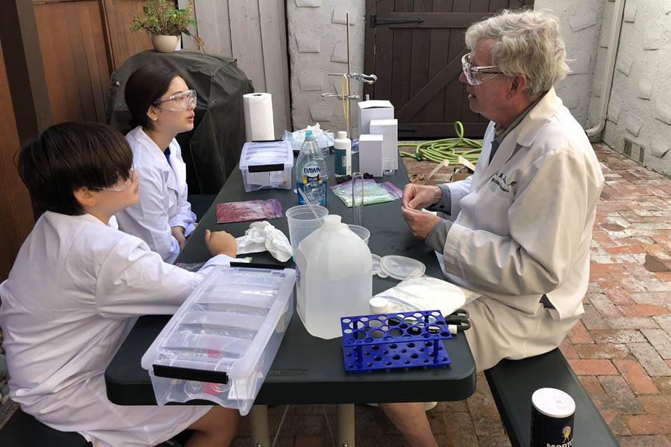 Robert Belshe, M.D., professor emeritus in the Division of Infectious Diseases, Allergy and Immunology and founder of Saint Louis University’s Center for Vaccine Development, teaches a science lesson to his grand kids during the COVID-19 pandemic. Photo Submitted. 