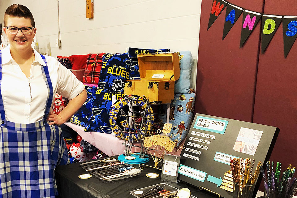 Emily Bishop stands with her wands and Harry Potter-inspired crafts.