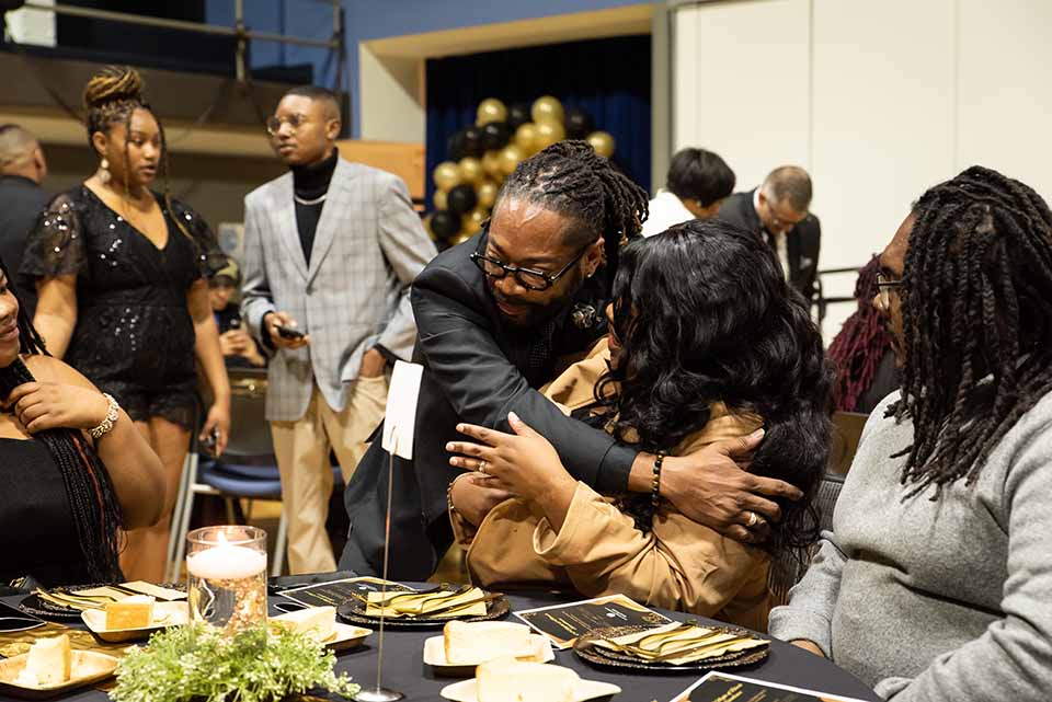 Richard B. Marks, Jr., Ed.D. assistant vice president in the Division of Diversity and Innovative Community Engagement, shares an embrace with an attendee of the Black History Month gala. The event, held Friday, Feb. 24, was designed to recognize and celebrate the achievements and success of Black faculty, staff and students at SLU. Photo by Luke Yamnitz.