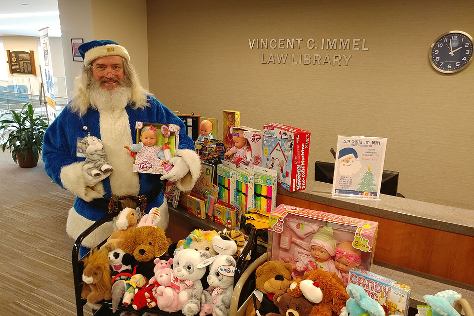 Blue Santa collects toys at the Law Library in 2018.