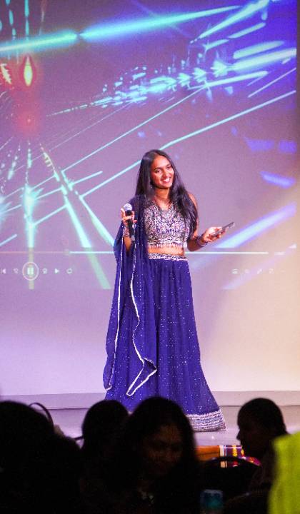 Srija Boddu sings on stage at the ICCA competition