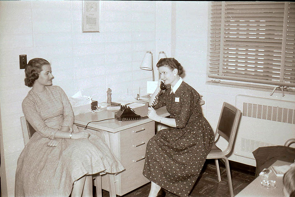 Mary Bruemmer assists a student in a 1950s archival photo.
