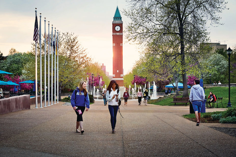 Students walking around on the SLU campus near the Clock Tower plaza.