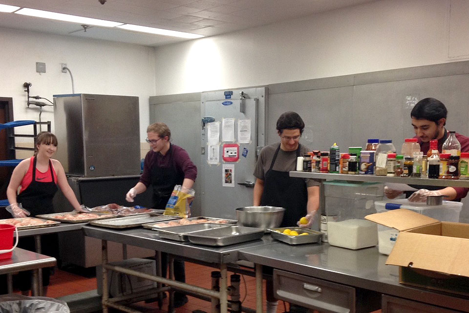Volunteers social distance while preparing meals at SLU's Campus Kitchen.