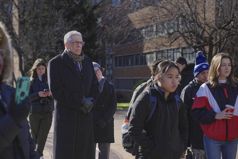 A photo of SLU President Dr. Fred Pestello standing with other attendees at the Campus Rally for Iran.
