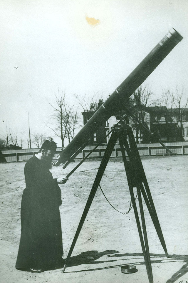 Charles Charropin, S.J. and telescope